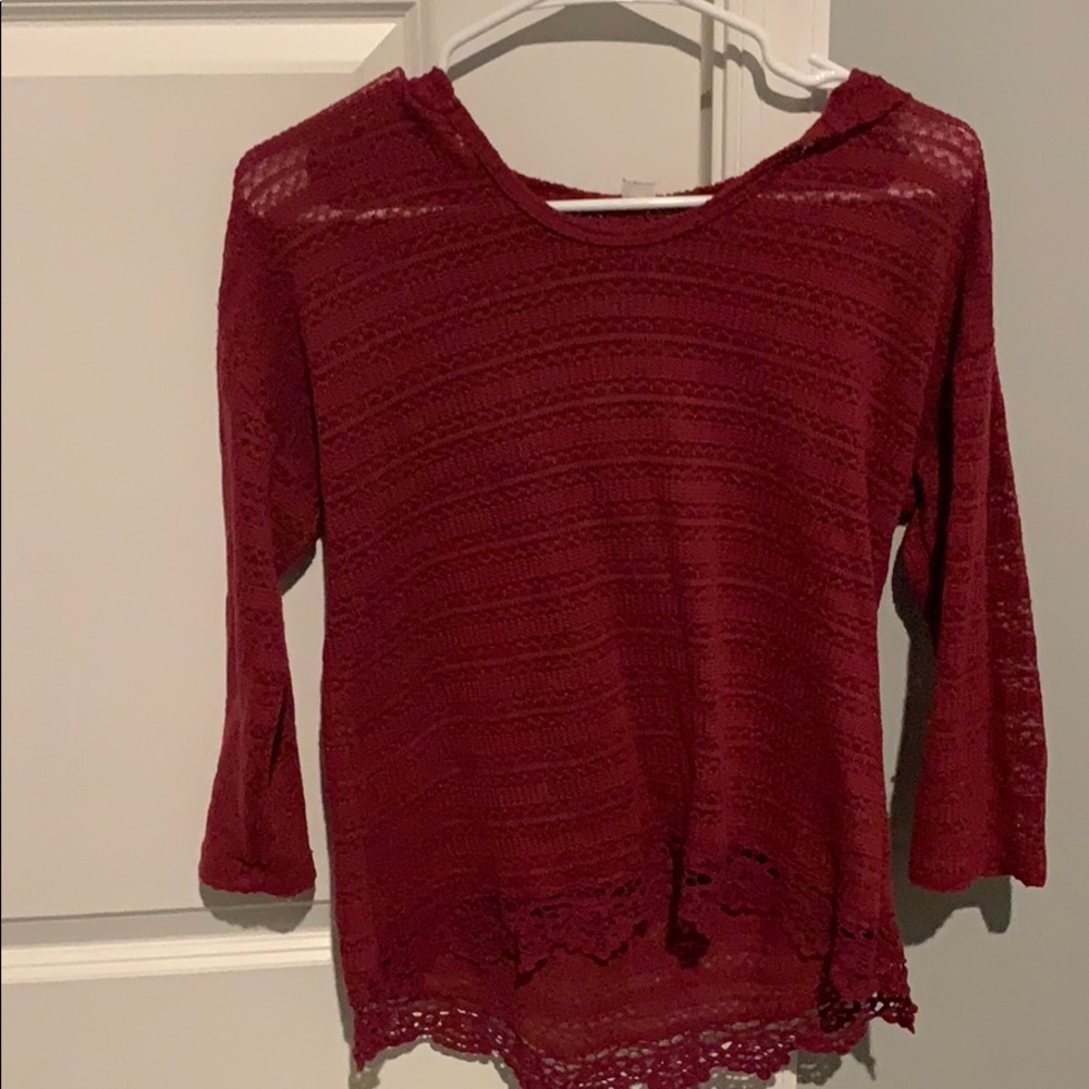 Red crocheted sweater with hood.